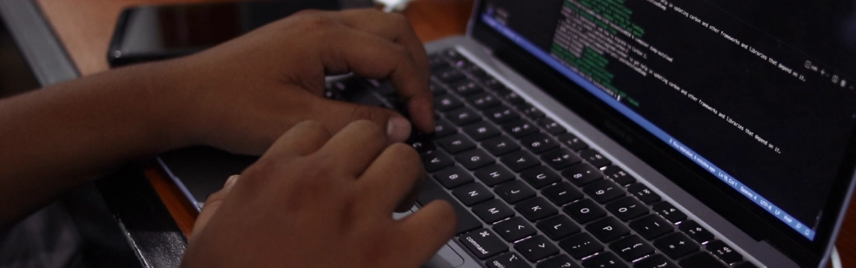 An employee doing a program on laptop