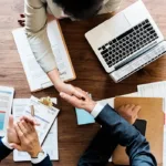 business people shaking hands together