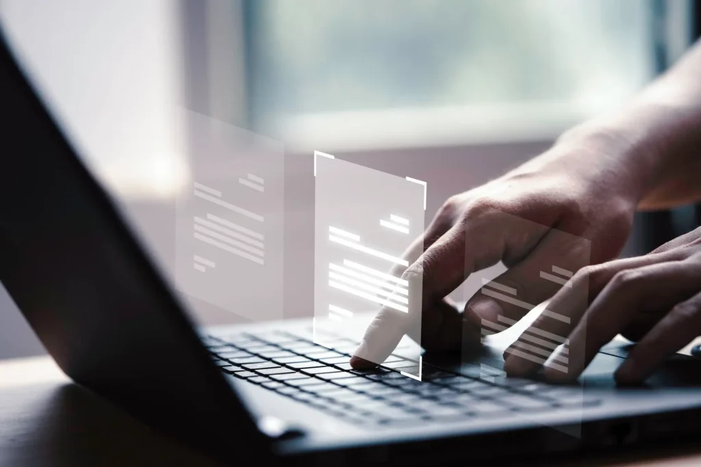 A person typing on a laptop keyboard, indicating a focus on digital documentation or editing.