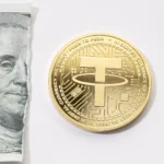 A gold coin placed in the middle of a ripped one-dollar bill.
