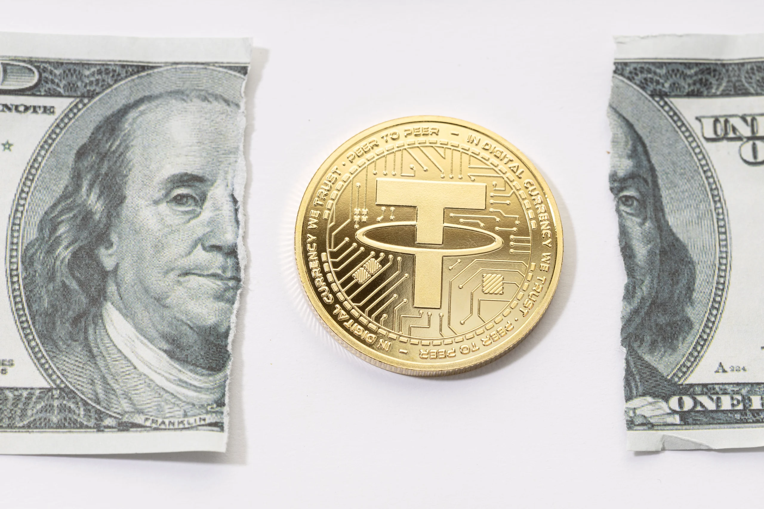 A tether coin placed in the middle of a ripped one-dollar bill.
