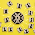 a wooden round target and wooden cubes with human figure