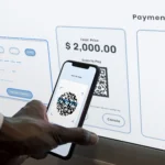 A person using a smartphone to complete a mobile payment for a product at a retail store.