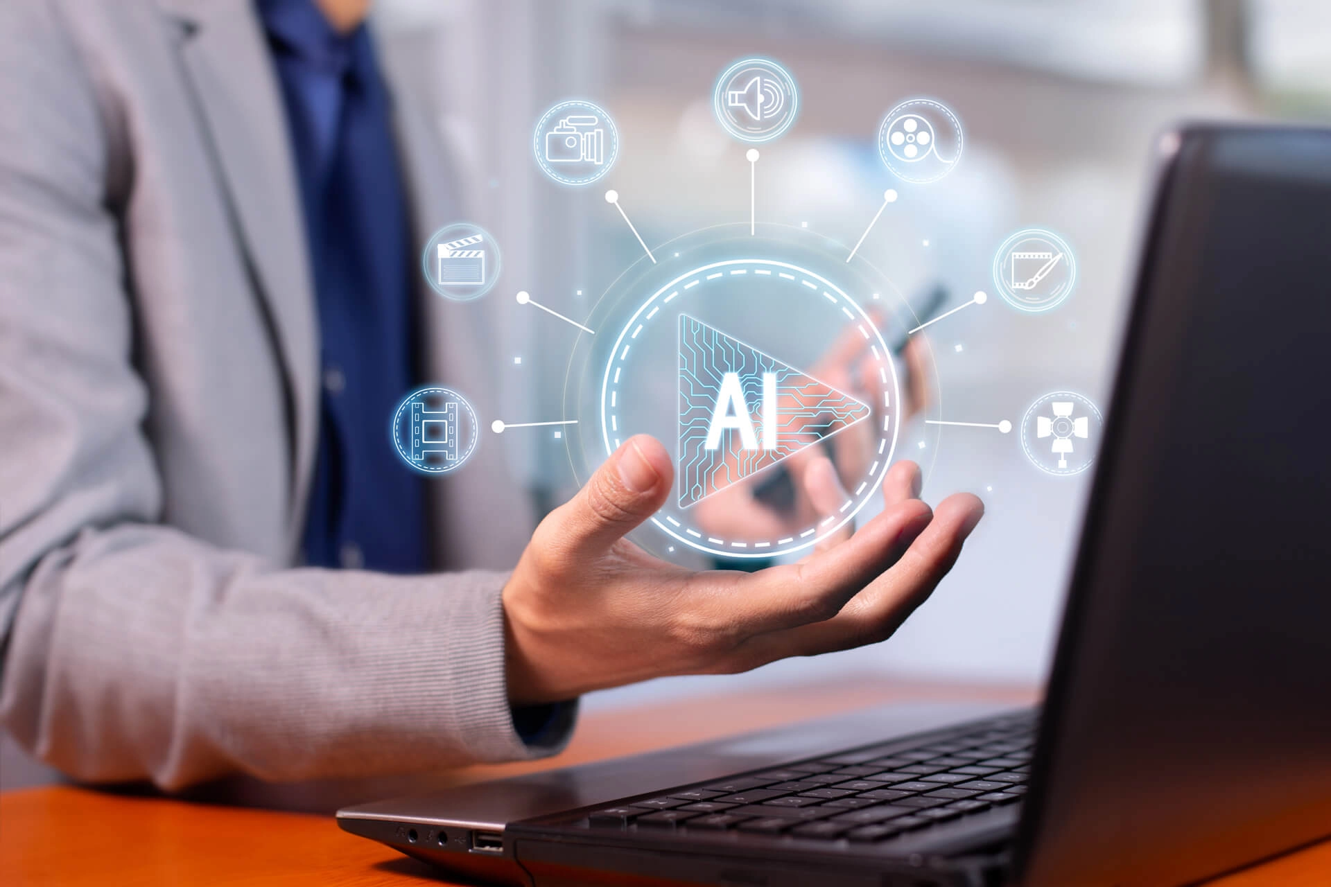 Person using a laptop with a futuristic AI chat interface hologram, symbolizing AI agents and digital communication.