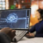 Individual working on a laptop with a graphic showcasing Visual Agentic AI Tools.